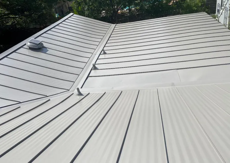 Solar attic fan installed on a metal roof for Roof Ventilation in Bridgetown